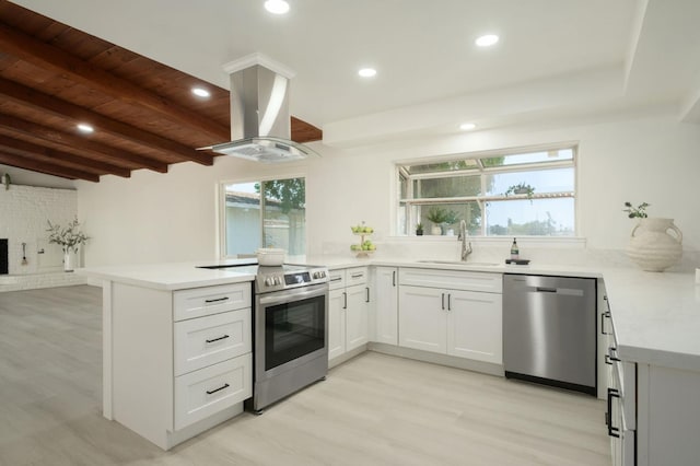 5610 N Arthur Ave, Fresno, CA 93711 - kitchen featuring stainless steel appliances, island range hood, a peninsula, light wood-type flooring, and light countertops