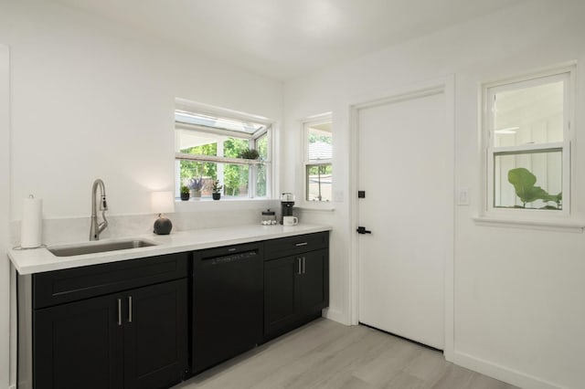 5610 N Arthur Ave, Fresno, CA 93711 - kitchen featuring dishwasher, light wood-type flooring, dark cabinets, and light countertops