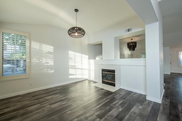 10485 N Sinclair Cir, Fresno, CA 93730 - unfurnished living room featuring a tiled fireplace, dark wood-type flooring, lofted ceiling, baseboards, and a chandelier