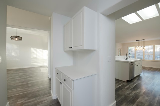 10485 N Sinclair Cir, Fresno, CA 93730 - kitchen featuring dark wood-type flooring, white cabinetry, stainless steel dishwasher, light countertops, and a sink