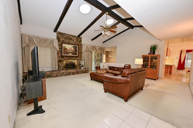 1911 W Simpson Ave, Fresno, CA 93705 - carpeted living area featuring a ceiling fan, a stone fireplace, and tile patterned flooring