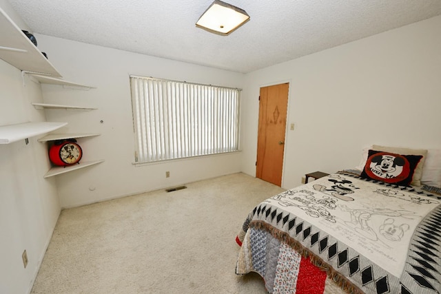 1911 W Simpson Ave, Fresno, CA 93705 - carpeted bedroom featuring a textured ceiling