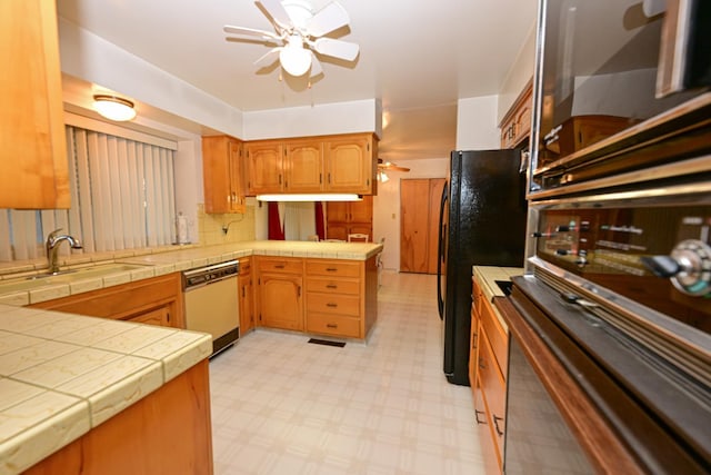 1911 W Simpson Ave, Fresno, CA 93705 - kitchen with white dishwasher, a sink, a peninsula, a ceiling fan, and freestanding refrigerator