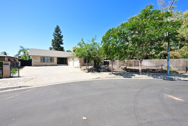 1911 W Simpson Ave, Fresno, CA 93705 - view of front of property with concrete driveway and a garage