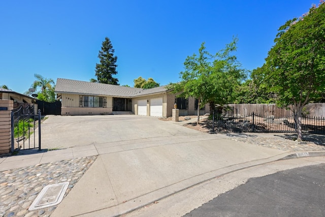 1911 W Simpson Ave, Fresno, CA 93705 - view of front of property with an attached garage, concrete driveway, and brick siding