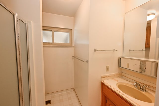 1911 W Simpson Ave, Fresno, CA 93705 - bathroom with vanity, a shower with shower door, and tile patterned floors