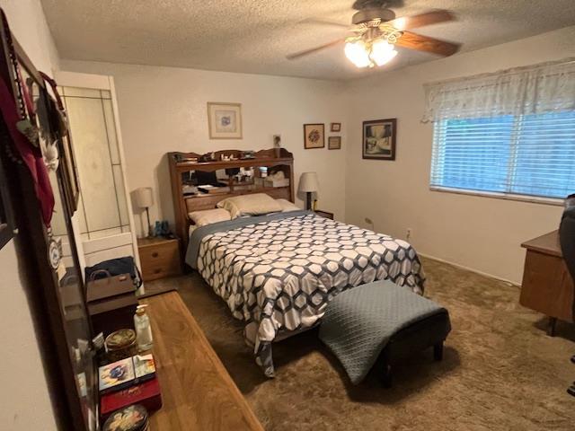 1173 Menlo Ave, Clovis, CA 93612 - bedroom with a textured ceiling, carpet floors, and a ceiling fan