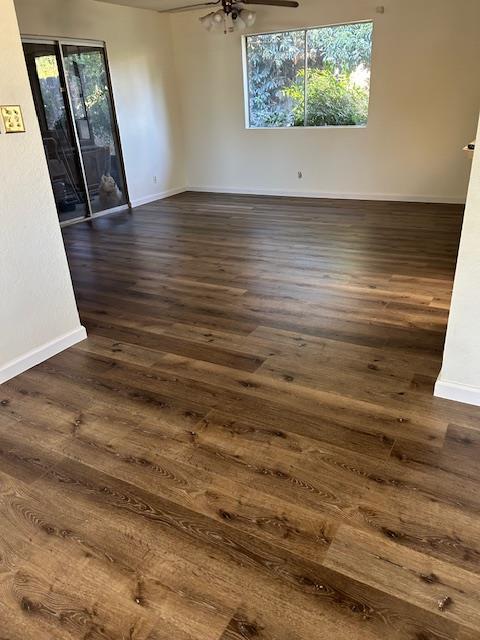 1173 Menlo Ave, Clovis, CA 93612 - empty room featuring baseboards, dark wood finished floors, and ceiling fan