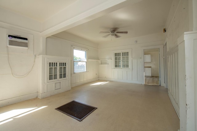 208 N 5th St, Fowler, CA 93625 - carpeted empty room featuring a ceiling fan, a decorative wall, and a wainscoted wall
