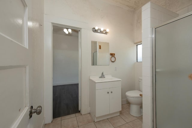 208 N 5th St, Fowler, CA 93625 - bathroom featuring toilet, a shower stall, vanity, and tile patterned flooring