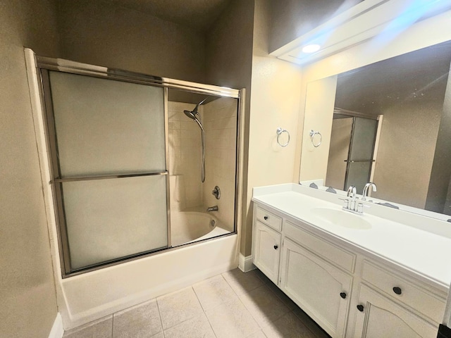 8147 N Cedar Ave Unit 115, Fresno, CA 93720 - bathroom featuring vanity, shower / bath combination with glass door, tile patterned flooring, and baseboards