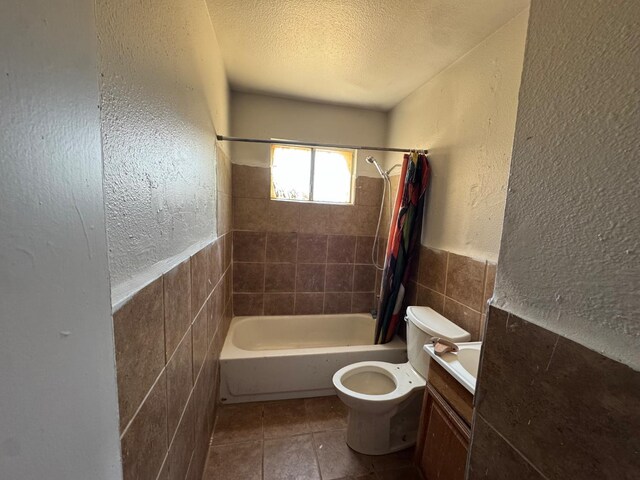 1546 W Orleans Ave, Fresno, CA 93706 - full bathroom featuring tile walls, a textured ceiling, shower / bath combo, vanity, and tile patterned flooring