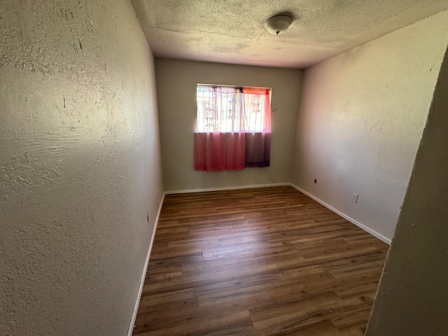 1546 W Orleans Ave, Fresno, CA 93706 - empty room featuring wood finished floors, a textured wall, and a textured ceiling
