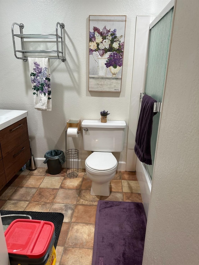 4885 N Backer Ave Unit 148, Fresno, CA 93726 - bathroom with toilet, vanity, baseboards, and stone finish flooring