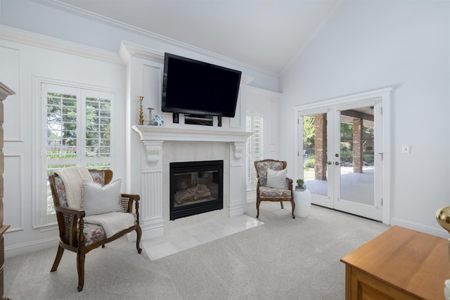8741 E Los Altos Ave, Clovis, CA 93619 - carpeted living area featuring a fireplace with flush hearth, crown molding, lofted ceiling, and french doors