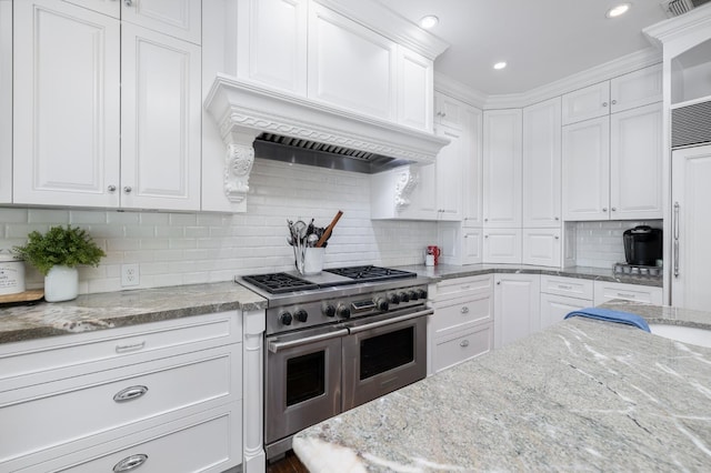 8741 E Los Altos Ave, Clovis, CA 93619 - kitchen with range with two ovens, white cabinetry, backsplash, light stone counters, and recessed lighting