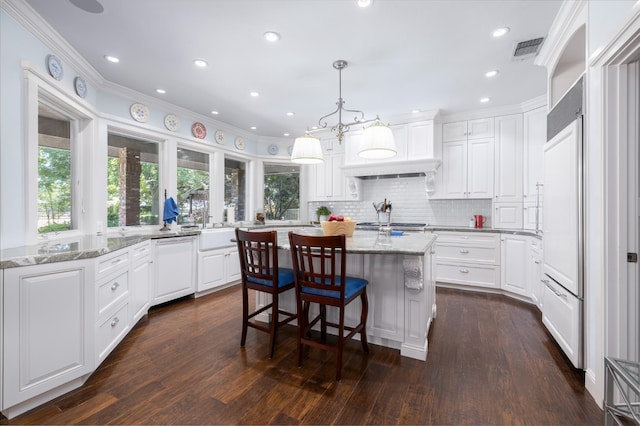 8741 E Los Altos Ave, Clovis, CA 93619 - kitchen with a center island, ornamental molding, white cabinetry, decorative backsplash, and light stone countertops