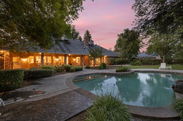 8741 E Los Altos Ave, Clovis, CA 93619 - pool at dusk with an outdoor pool