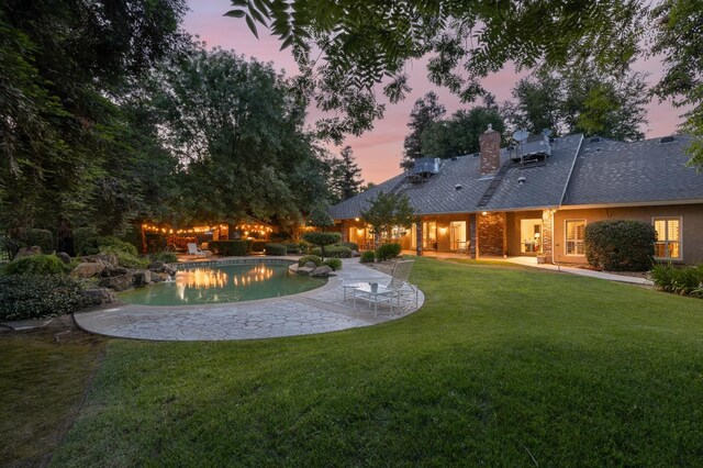 8741 E Los Altos Ave, Clovis, CA 93619 - back of house featuring a patio area, a lawn, an outdoor pool, a chimney, and roof with shingles