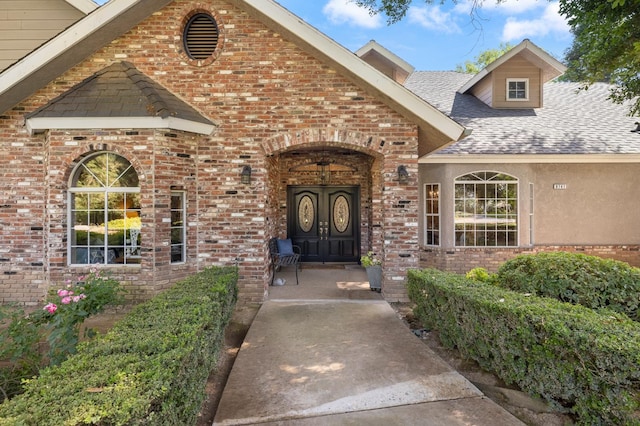 8741 E Los Altos Ave, Clovis, CA 93619 - view of exterior entry featuring a shingled roof, brick siding, and french doors