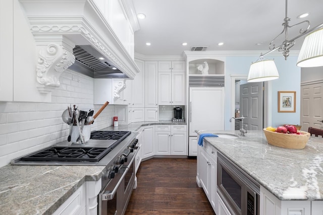 8741 E Los Altos Ave, Clovis, CA 93619 - kitchen featuring white cabinets, appliances with stainless steel finishes, custom range hood, decorative backsplash, and a sink