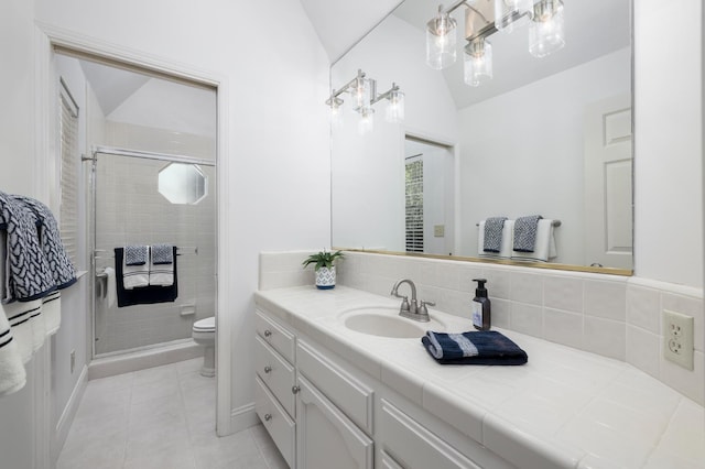 8741 E Los Altos Ave, Clovis, CA 93619 - full bath featuring toilet, vaulted ceiling, vanity, a shower stall, and tile patterned floors