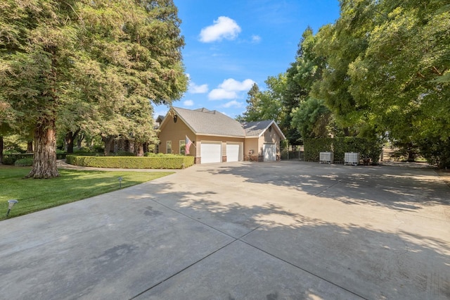 8741 E Los Altos Ave, Clovis, CA 93619 - view of front of property featuring concrete driveway, a front yard, and a garage