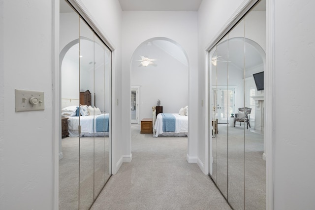 8741 E Los Altos Ave, Clovis, CA 93619 - hallway with light carpet, arched walkways, and baseboards