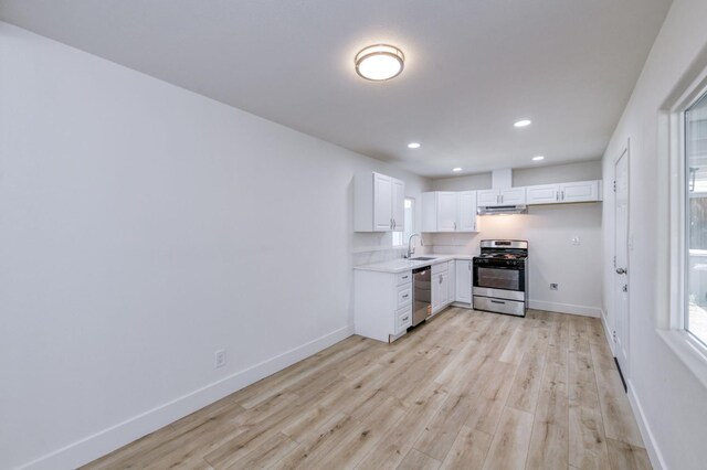 3722 N Hammel Way, Fresno, CA 93727 - kitchen with appliances with stainless steel finishes, recessed lighting, baseboards, light countertops, and light wood-style flooring