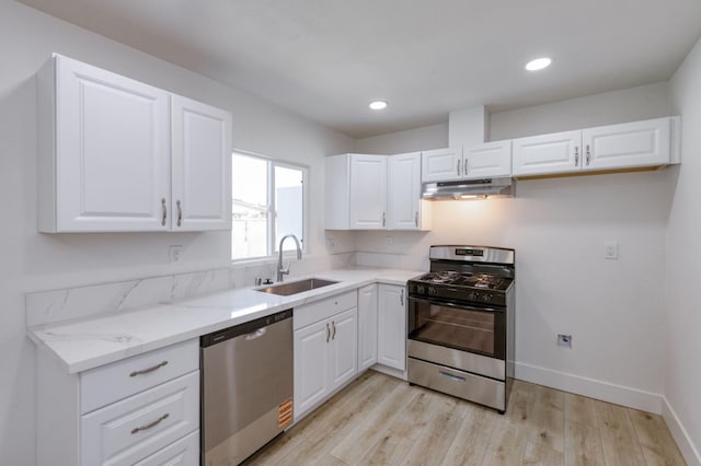 3722 N Hammel Way, Fresno, CA 93727 - kitchen with stainless steel appliances, under cabinet range hood, a sink, light wood-type flooring, and light stone counters