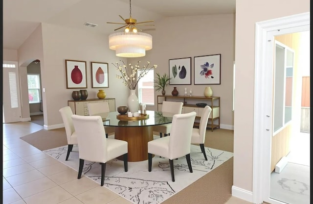 7285 W San Jose Ave, Fresno, CA 93723 - tiled dining area featuring arched walkways, lofted ceiling, ceiling fan, and baseboards