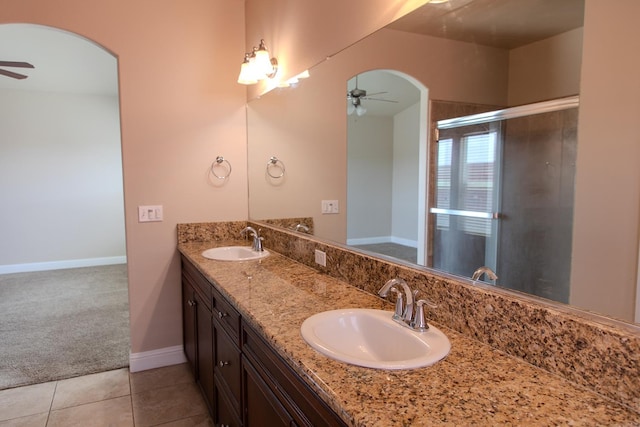 7285 W San Jose Ave, Fresno, CA 93723 - bathroom featuring a ceiling fan, double vanity, baseboards, and an enclosed shower