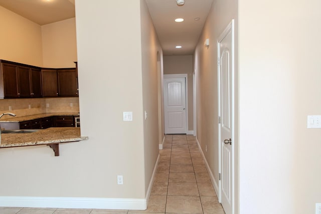7285 W San Jose Ave, Fresno, CA 93723 - corridor featuring a sink, light tile patterned floors, recessed lighting, and baseboards