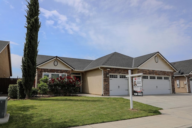 7285 W San Jose Ave, Fresno, CA 93723 - view of front of home featuring an attached garage, stone siding, a front lawn, and concrete driveway