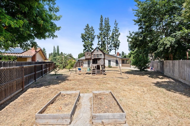 772 W Menlo Ave, Clovis, CA 93612 - fenced backyard featuring a playground and a vegetable garden