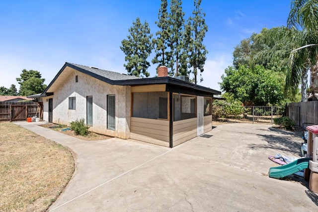 772 W Menlo Ave, Clovis, CA 93612 - view of home's exterior with a patio area, a fenced backyard, a chimney, and stucco siding