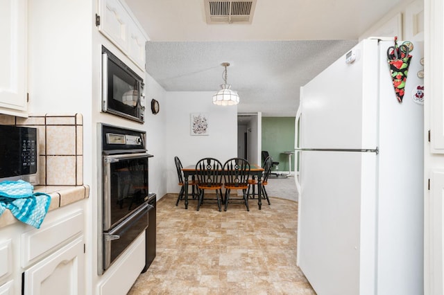 772 W Menlo Ave, Clovis, CA 93612 - kitchen featuring black appliances, a warming drawer, white cabinets, light countertops, and pendant lighting