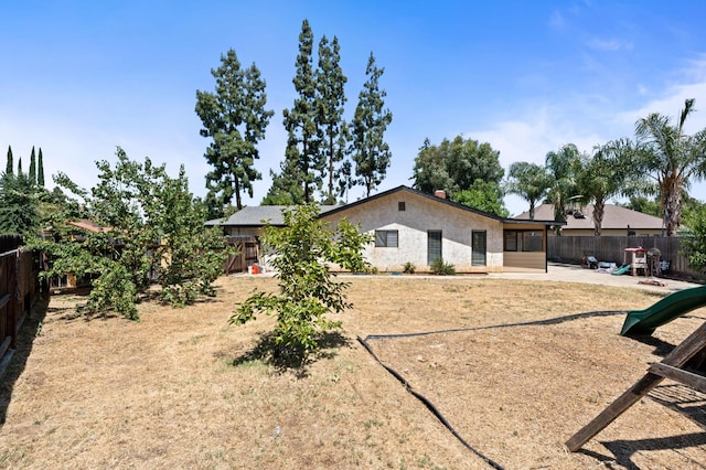 772 W Menlo Ave, Clovis, CA 93612 - rear view of property with a fenced backyard, a patio area, a playground, and stucco siding