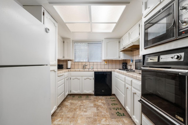 772 W Menlo Ave, Clovis, CA 93612 - kitchen with black appliances, tile counters, white cabinets, and under cabinet range hood