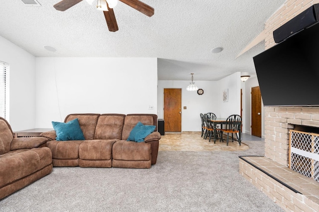 772 W Menlo Ave, Clovis, CA 93612 - carpeted living area with ceiling fan, a textured ceiling, and a fireplace