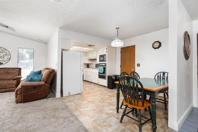 772 W Menlo Ave, Clovis, CA 93612 - dining room featuring a textured ceiling, baseboards, and vaulted ceiling