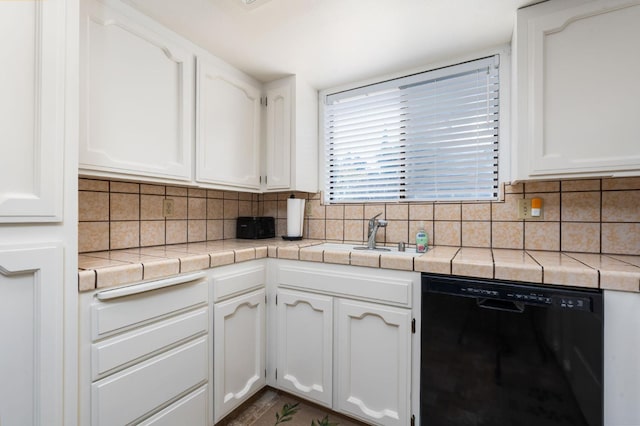 772 W Menlo Ave, Clovis, CA 93612 - kitchen featuring black dishwasher, white cabinetry, a sink, decorative backsplash, and tile countertops