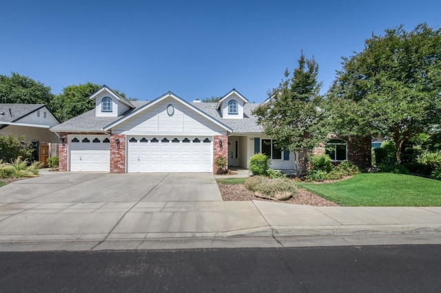770 N Cherry Ln, Clovis, CA 93611 - view of front of house with a garage, brick siding, driveway, and a front lawn