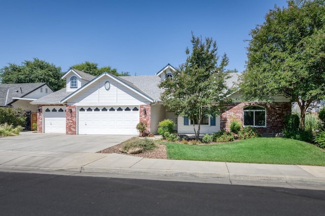 770 N Cherry Ln, Clovis, CA 93611 - view of front of house with brick siding, an attached garage, a front yard, and concrete driveway