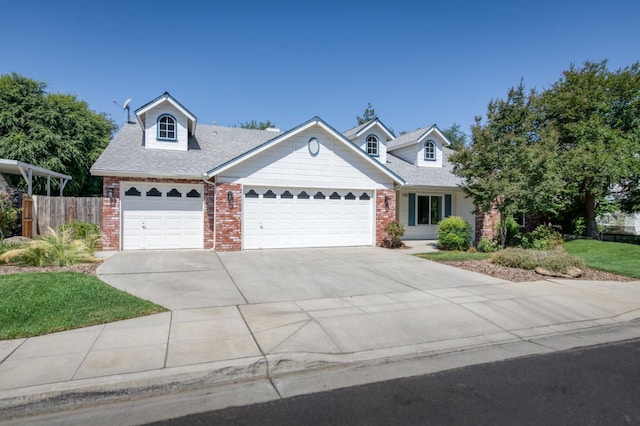 770 N Cherry Ln, Clovis, CA 93611 - view of front facade featuring brick siding, a garage, concrete driveway, and a shingled roof