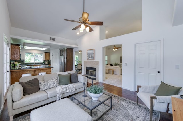 770 N Cherry Ln, Clovis, CA 93611 - living area featuring ceiling fan, wood finished floors, a fireplace, high vaulted ceiling, and baseboards
