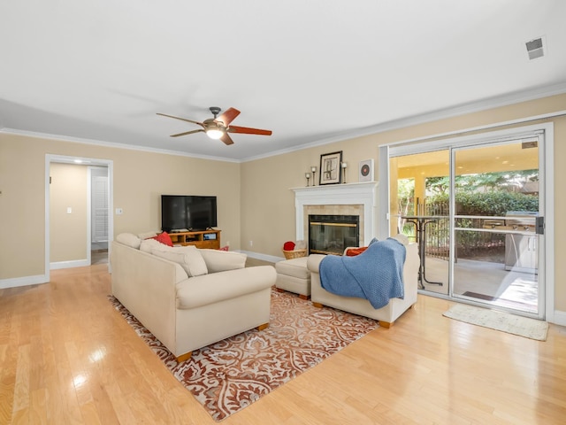 811 E Country View Cir, Fresno, CA 93730 - living area with wood finished floors, crown molding, a ceiling fan, and a fireplace