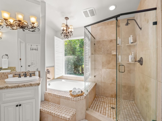 811 E Country View Cir, Fresno, CA 93730 - bathroom with a bath, vanity, a shower stall, a chandelier, and recessed lighting