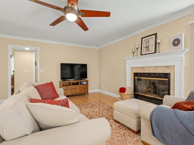 811 E Country View Cir, Fresno, CA 93730 - living room featuring light wood finished floors, crown molding, ceiling fan, and a tile fireplace
