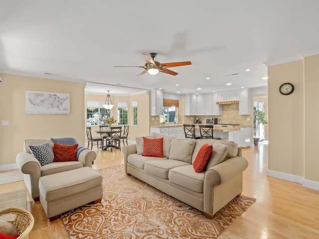 811 E Country View Cir, Fresno, CA 93730 - living area featuring a ceiling fan, light wood-style floors, recessed lighting, and ornamental molding